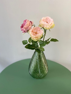 Rose floral arrangement in green vase