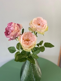 Rose floral arrangement in green vase
